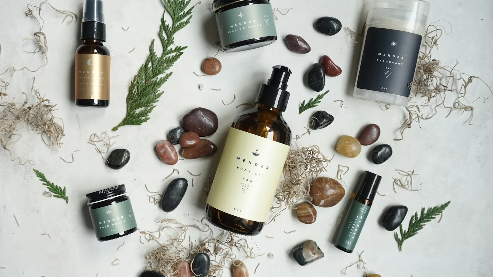 Wellness product line laid out on a neutral surface with stones and natural elements